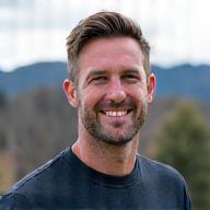 Smiling portrait of Coach Kai Rivers, a man in his early 50s