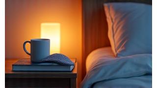 A serene bedroom scene featuring a sleep mask, herbal tea, and a book on a nightstand, promoting restful sleep.