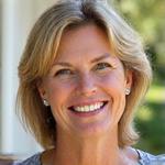 Woman in her early 40s, Emily R., glowing outdoors, perhaps after a run, showing clear skin.