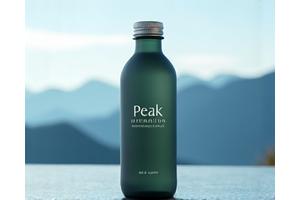 Bottle of a high-altitude electrolyte supplement with a mountain background.